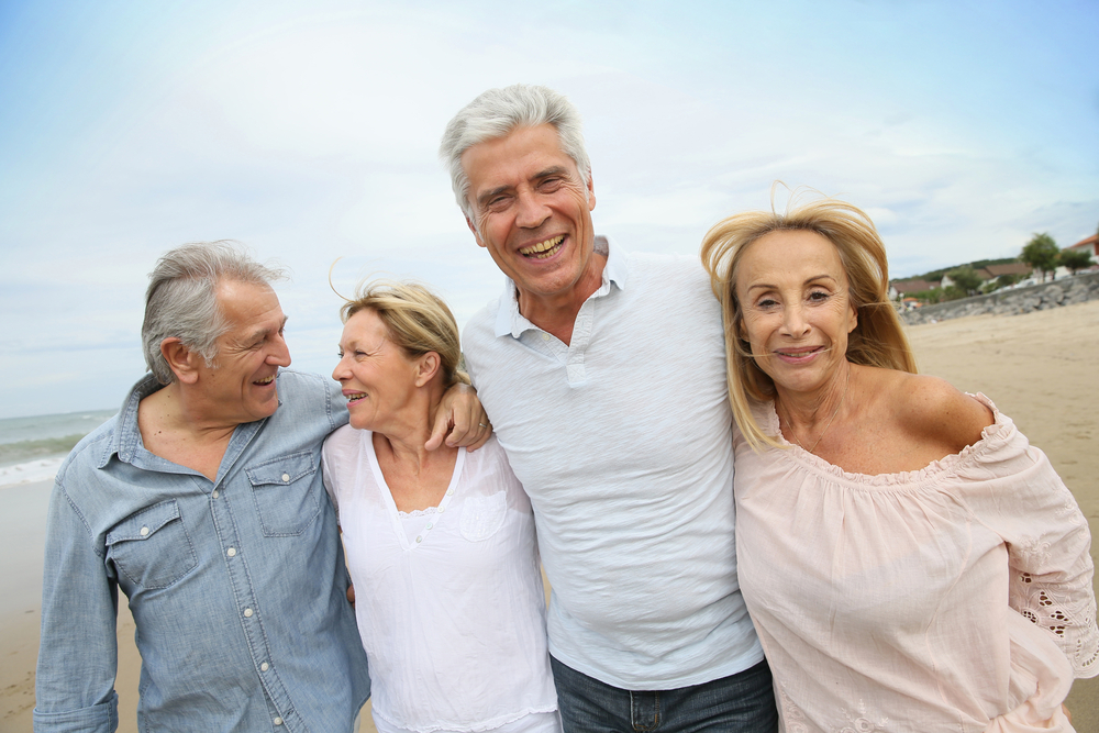 Senior people walking on the beach